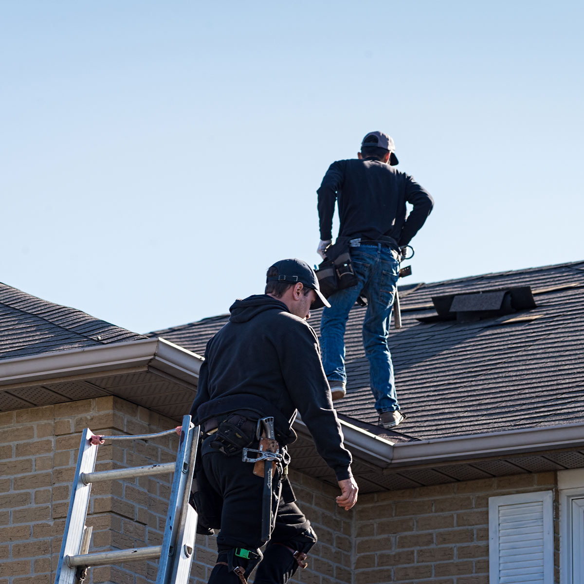 workers inspecting residential roof