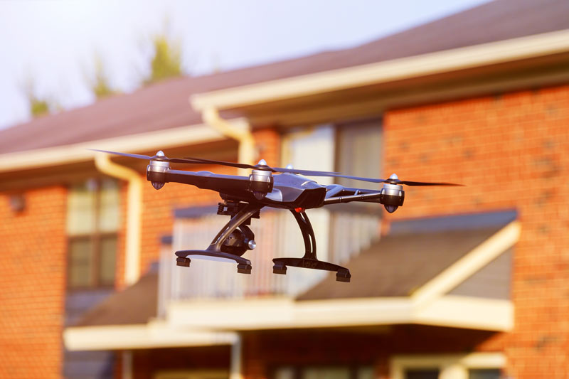 drone inspecting roof of apartment complex